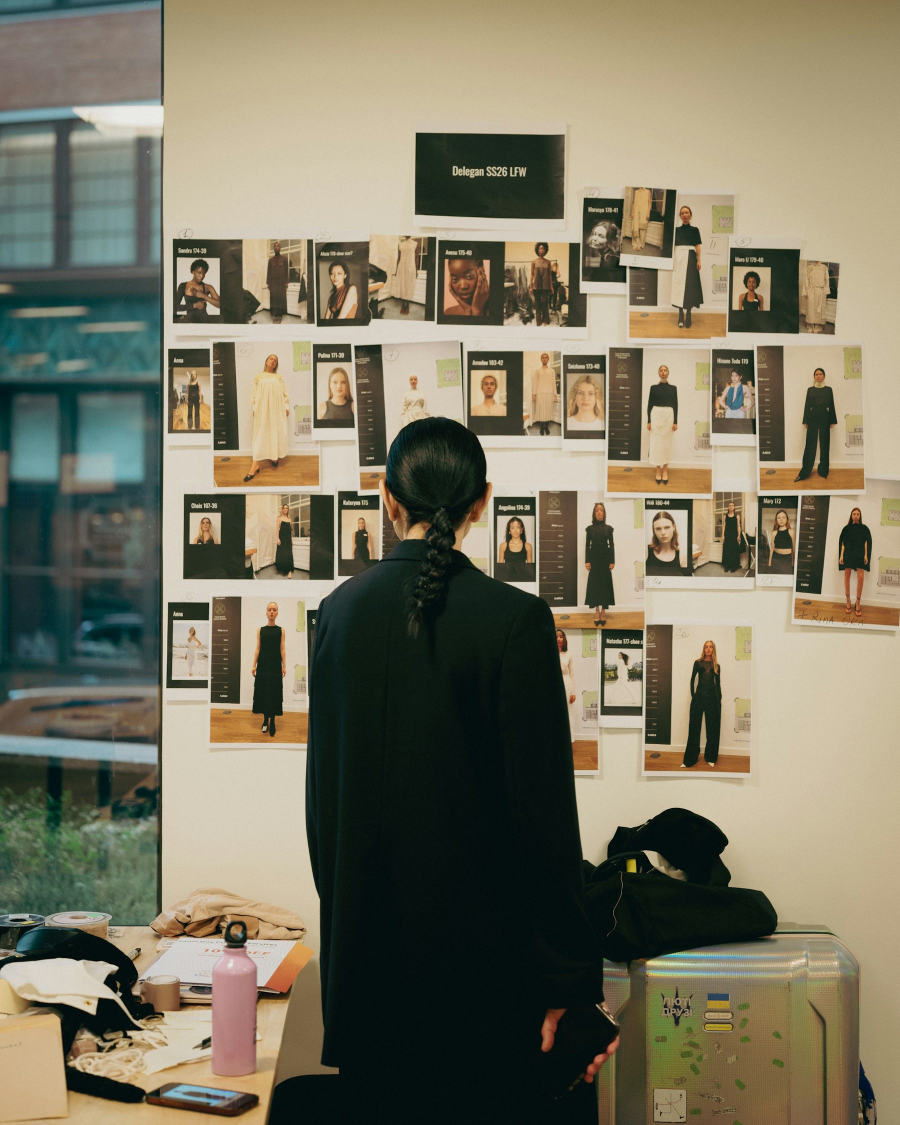Fashion designer reviewing a mood board and collection direction